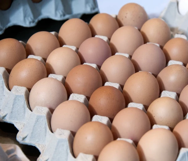 A large carton of brown eggs neatly arranged and ready for use.